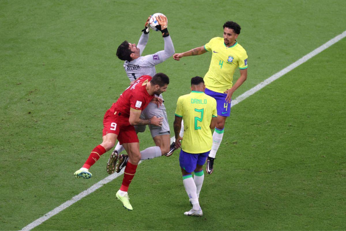 Alisson Becker of Brazil makes a save against Aleksandar Mitrovic of Serbia