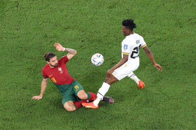 Ruben Neves of Portugal battles for possession with Mohammed Kudus of Ghana