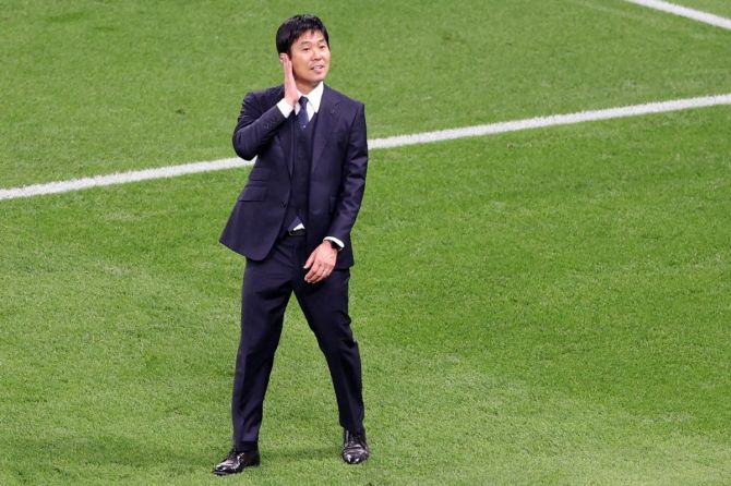 Japan coach Hajime Moriyasu celebrates after the match against Germany.