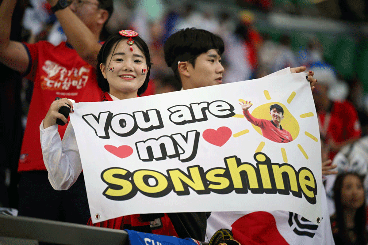 Korea Republic fans with a placard for their talisman prior to the FIFA World Cup Group H match against  Uruguay at Education City Stadium in Al Rayyan, Qatar, on Thursday 