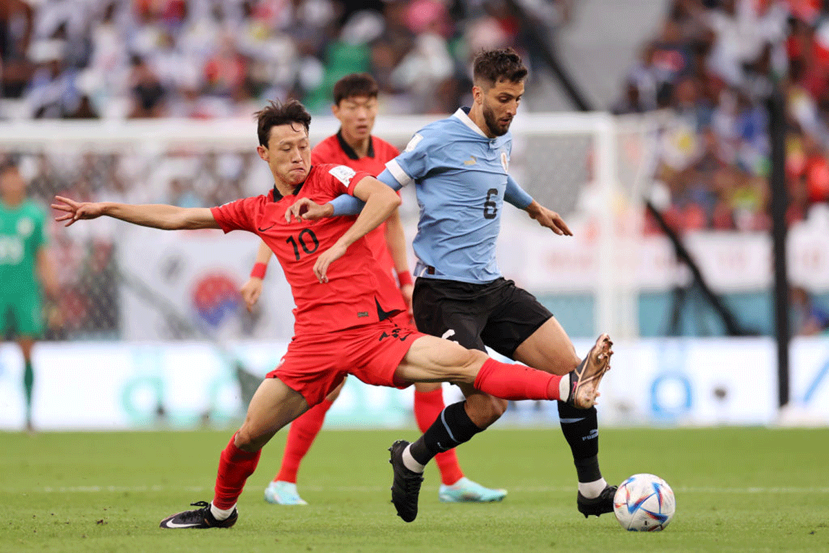 Uruguay's Rodrigo Bentancur battles for possession with South Korea's Jaesung Lee