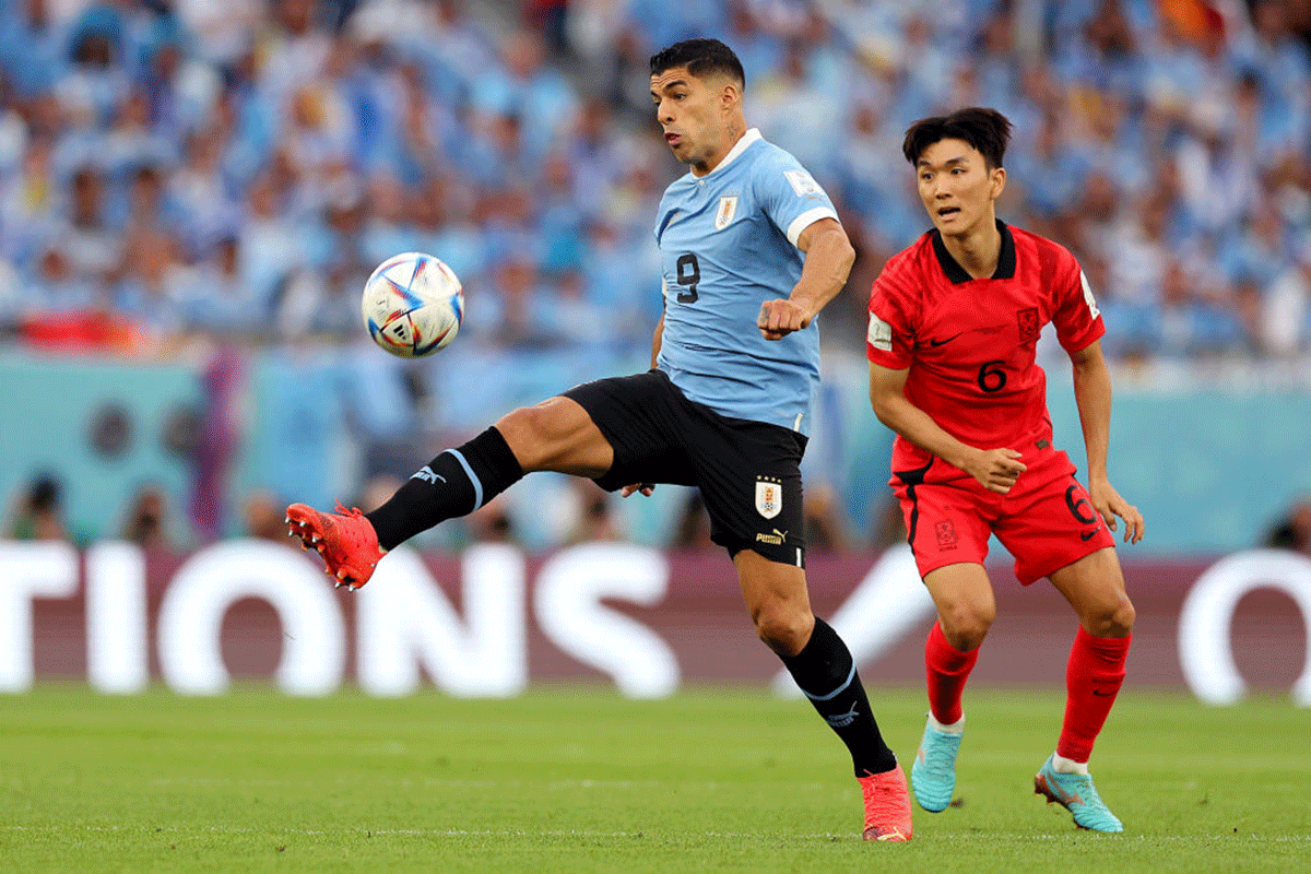 Uruguay's Luis Suarez controls the ball against South Korea's Inbeom Hwang