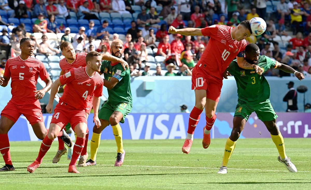 Granit Xhaka competes for a header against Nicolas Nkoulou