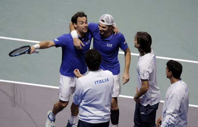 Italy's Simone Bolelli and Fabio Fognini celebrate with teammates after winning the doubles match in the Davis Cup Finals quarter-final against Tommy Paul and Jack Sock of the United States