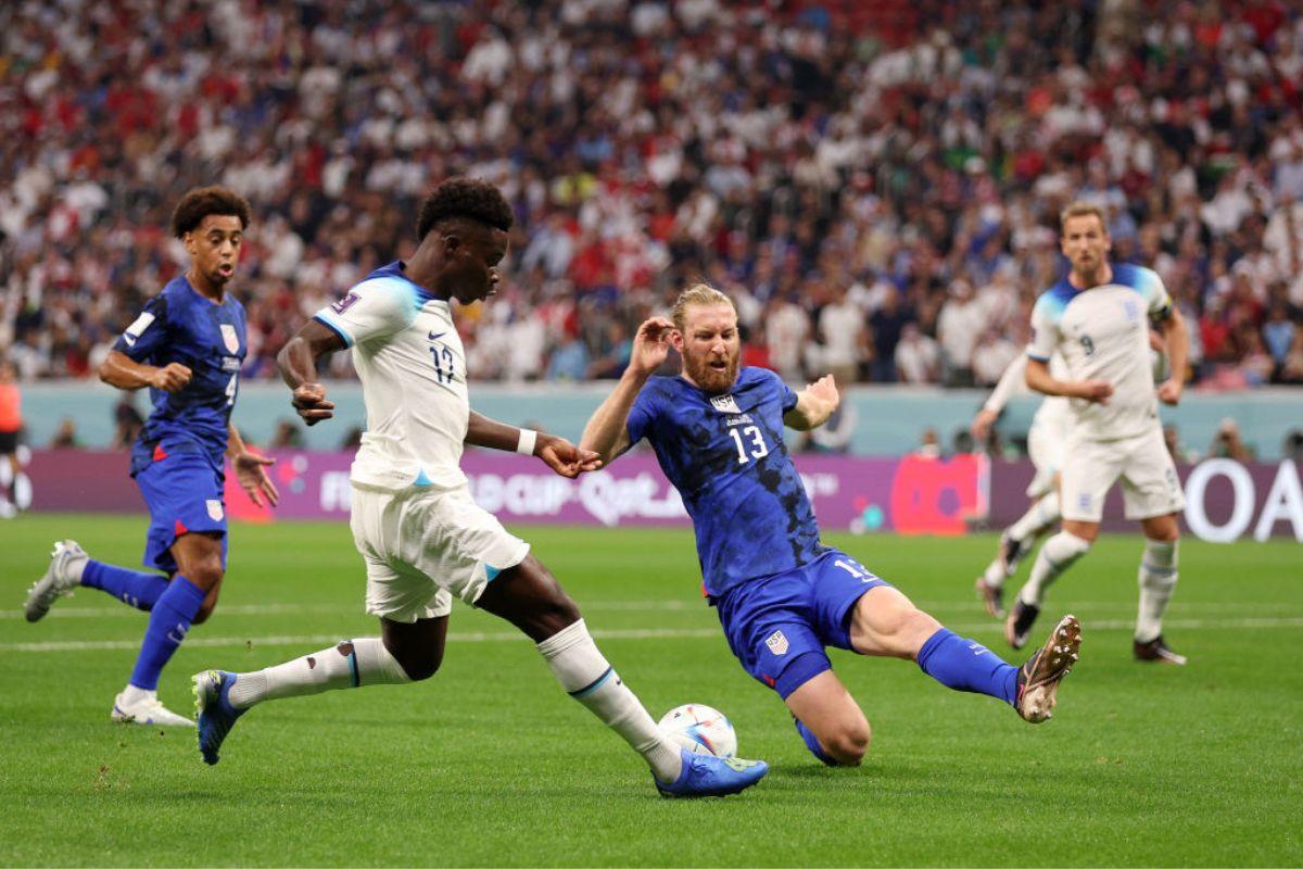 Tim Ream of United States defends Bukayo Saka of England 