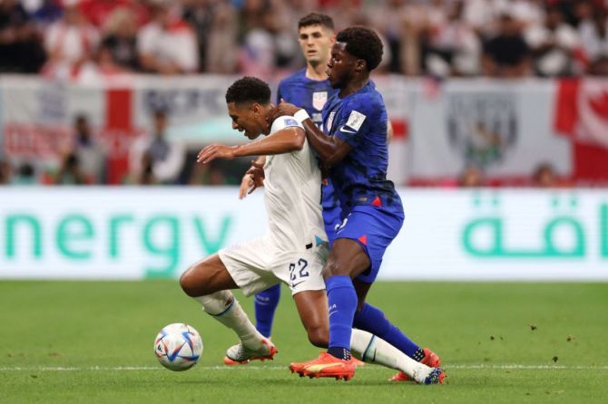England's Jude Bellingham is challenged by USA's Yunus Musah.