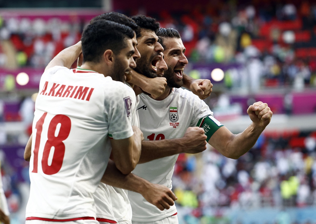 Iran's Karim Ansarifard and teammates celebrate beating Wales on Thursday 
