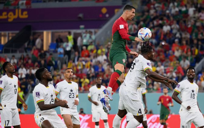 Cristiano Ronaldo competes for a header with Mohammed Ghana's Salisu.