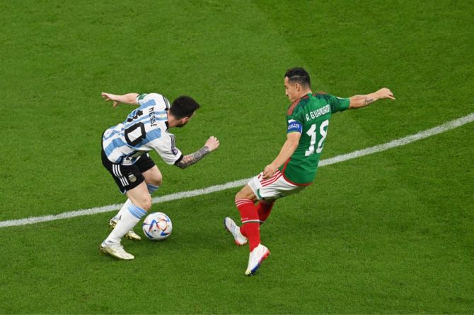 Lionel Messi of Argentina takes on Andres Guardado of Mexico
