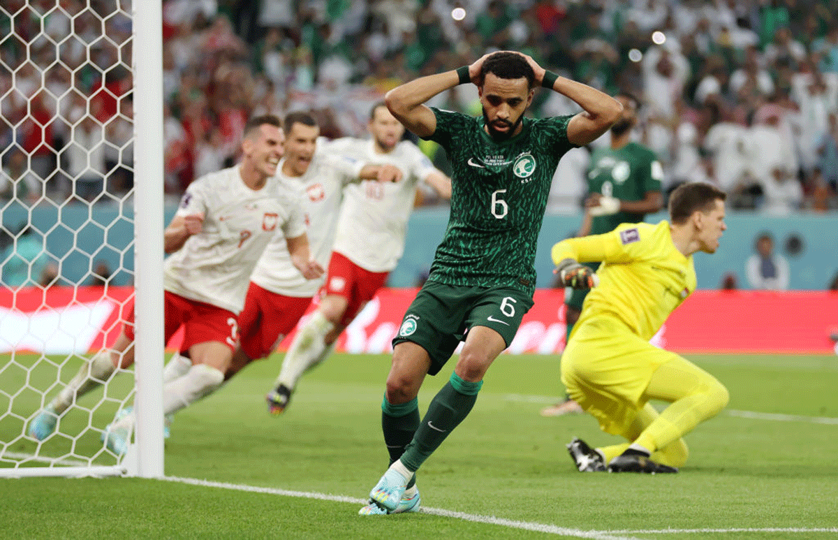 Saudi Arabia's Mohammed Alburayk reacts after their attempt was saved by Poland's Wojciech Szczesny