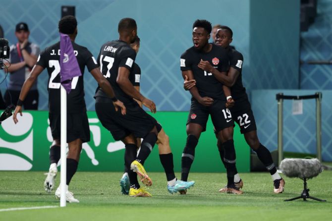 Canada's Alphonso Davies (2nd R) celebrates after scoring his team's first goal with teammates