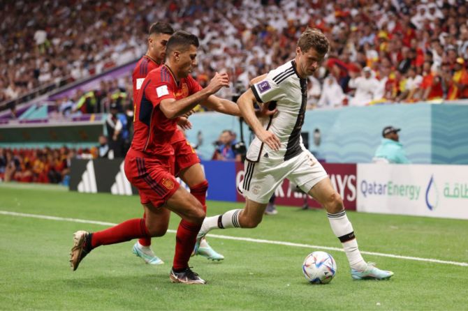 Thomas Mueller of Germany battles for possession with Rodri of Spain