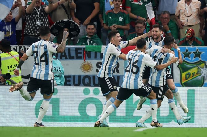 Lionel Messi is congratulated by his Argentina teammates after scoring.