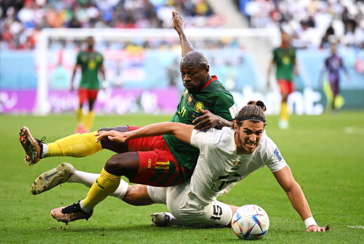 Cameroon's Christian Bassogog battles for possession with Serbia's Srdjan Babic