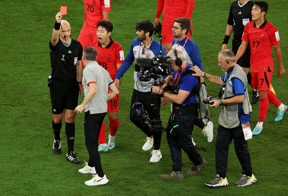 Paulo Bento, Head Coach of Korea Republic, is shown a red card by referee Anthony Taylor