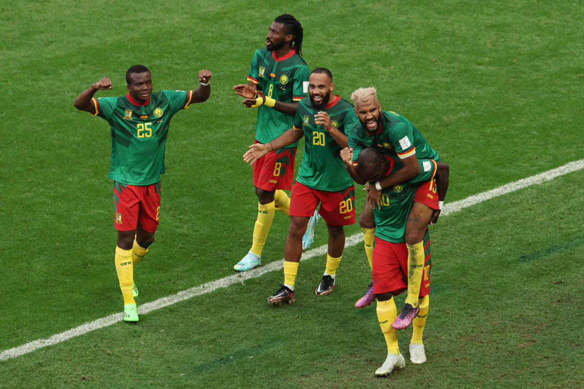 Cameroon's Eric Maxim Choupo-Moting celebrates with teammates after scoring their team's third goal and the equliser against Serbia