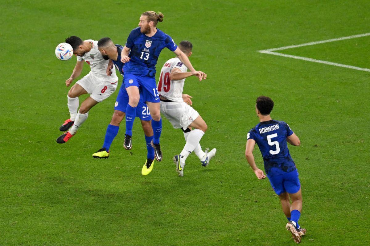 Morteza Pouraliganji of IR Iran jumps for the ball with Cameron Carter-Vickers and Tim Ream of United States during the FIFA World Cup Qatar 2022 Group B match between IR Iran and USA