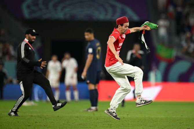 A pitch invader runs on the pitch during the FIFA World Cup Qatar 2022 Group D match between Tunisia and France