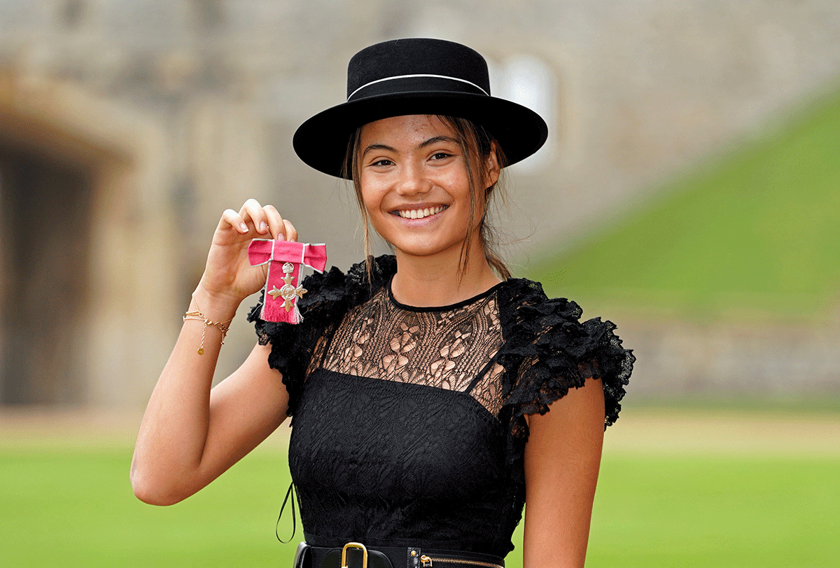 British tennis player Emma Raducanu poses after being made a Member of the Order of the British Empire by King Charles III during an investiture ceremony at Windsor Castle on Tuesday