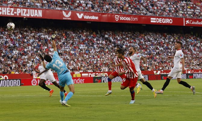 Alvaro Morata lobs the ball over goalkeeper Bono to score Atletico Madrid's second goal against Sevilla.