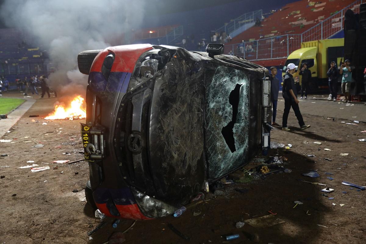 A damaged car is pictured following a riot after the BRI Liga 1 football match between Arema vs Persebaya at Kanjuruhan Stadium, Malang, East Java province, Indonesia, on Saturday.