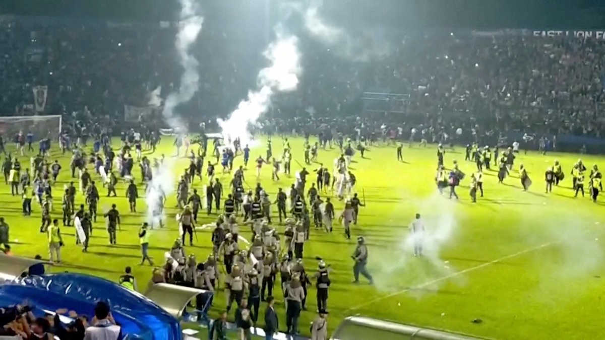 Fans invade the soccer field after a match between Arema FC and Persebaya Surabaya at Kanjuruhan Stadium, Malang, Indonesia on Saturday in this screen grab taken from a REUTERS video.