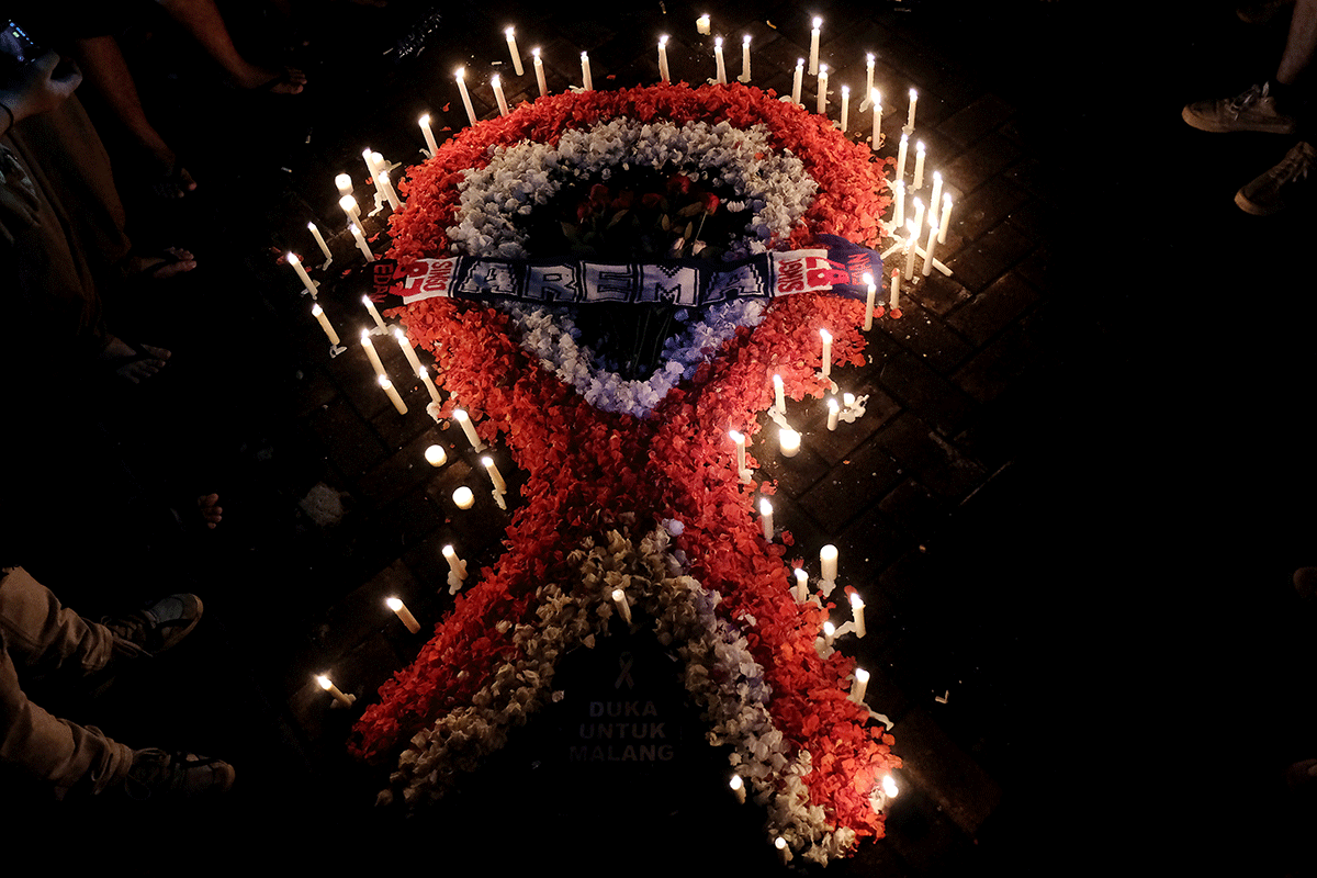 Ribbon-shaped candles and petals are pictured during a vigil, after a riot and stampede following a soccer match between Arema vs Persebaya in Denpasar, Bali, Indonesia, on Sunday