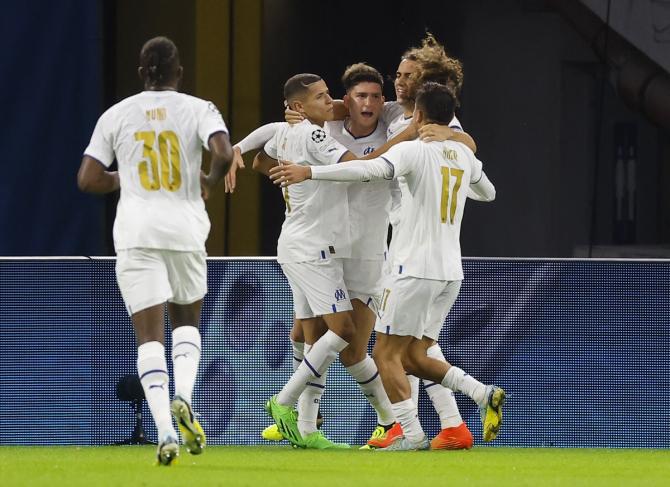 Leonardo Balerdi celebrates scoring Olympique de Marseille's third goal with teammates during the Champions League Group D match against Sporting CP at Orange Velodrome, Marseille, France.