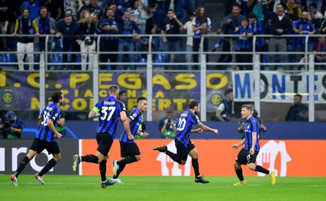Hakan Calhanoglu, centre, celebrates scoring what turned out to be the all-important goal for Inter Milan's in the Group C match against Barcelona at San Siro, Milan, Italy.