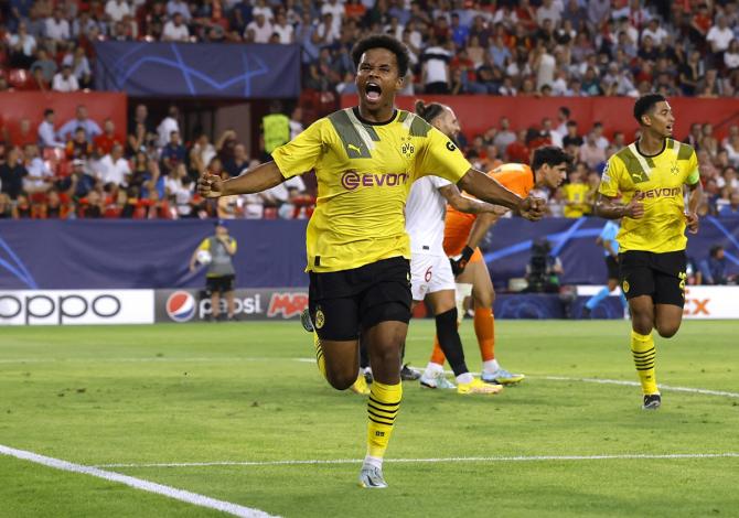 Karim Adeyemi celebrates scoring Borussia Dortmund's third goal in the Champions League Group G match against Sevilla at Ramon Sanchez Pizjuan, Seville, Spain.