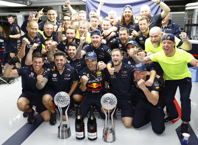 The Red Bull team celebrates with Max Verstappen's and Sergio Perez after the Japanese Grand Prix.