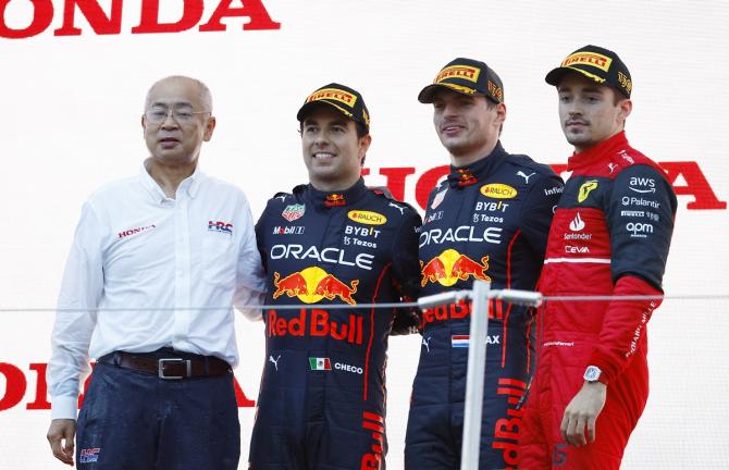 Max Verstappen on the podium with second-placed Red Bull's Sergio Perez and third-placed Ferrari's Charles Leclerc. 