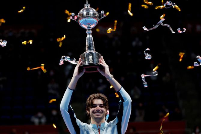 Taylor Fritz of the U.S. celebrates with the trophy after winning the men's singles final against Frances Tiafoe