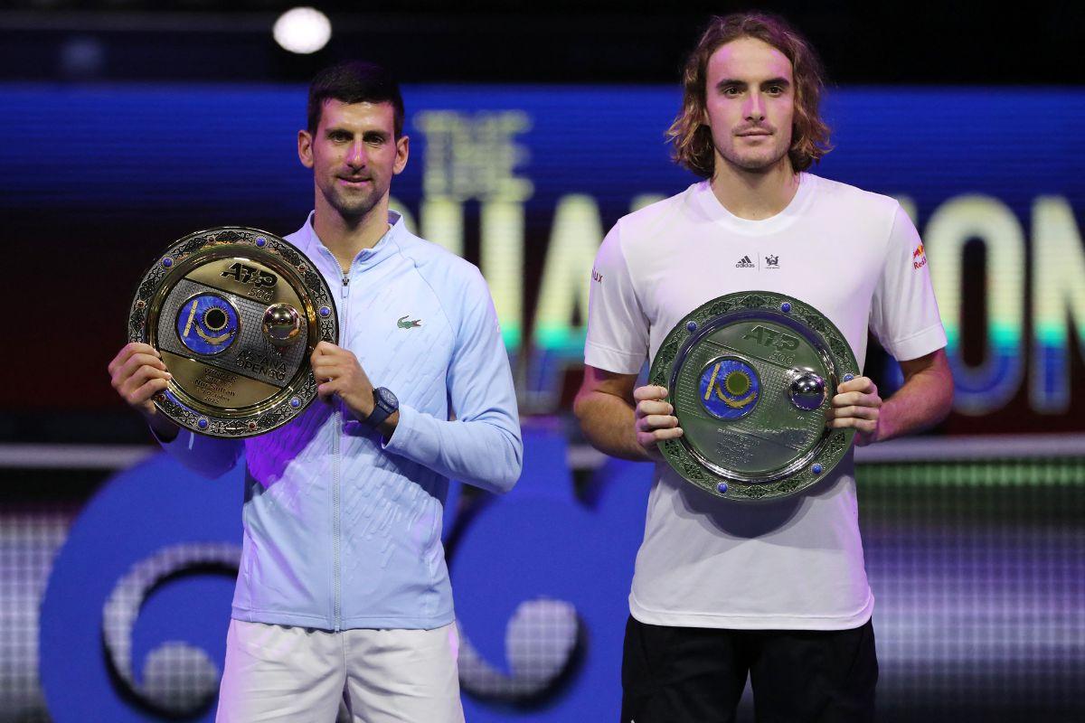 Novak Djokovic poses with a trophy after winning the men's singles final against Greece's Stefanos Tsitsipas