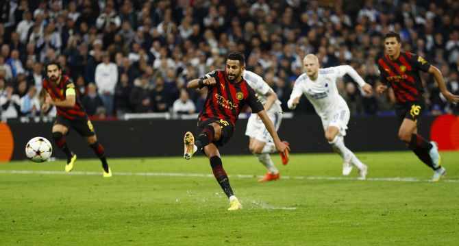 Manchester City's Riyad Mahrez takes a penalty kick that is saved by FC Copenhagen's Kamil Grabara during the Group G match at Parken, Copenhagen, Denmark.