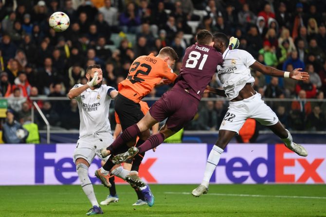Antonio Rudiger scores a last-gasp equaliser for Real Madrid as he clashes with Shakhtar Donetsk goalkeeper Anatoliy Trubin during the Champions League group F match at Wojska Polskiego Stadium in Warsaw, Poland.