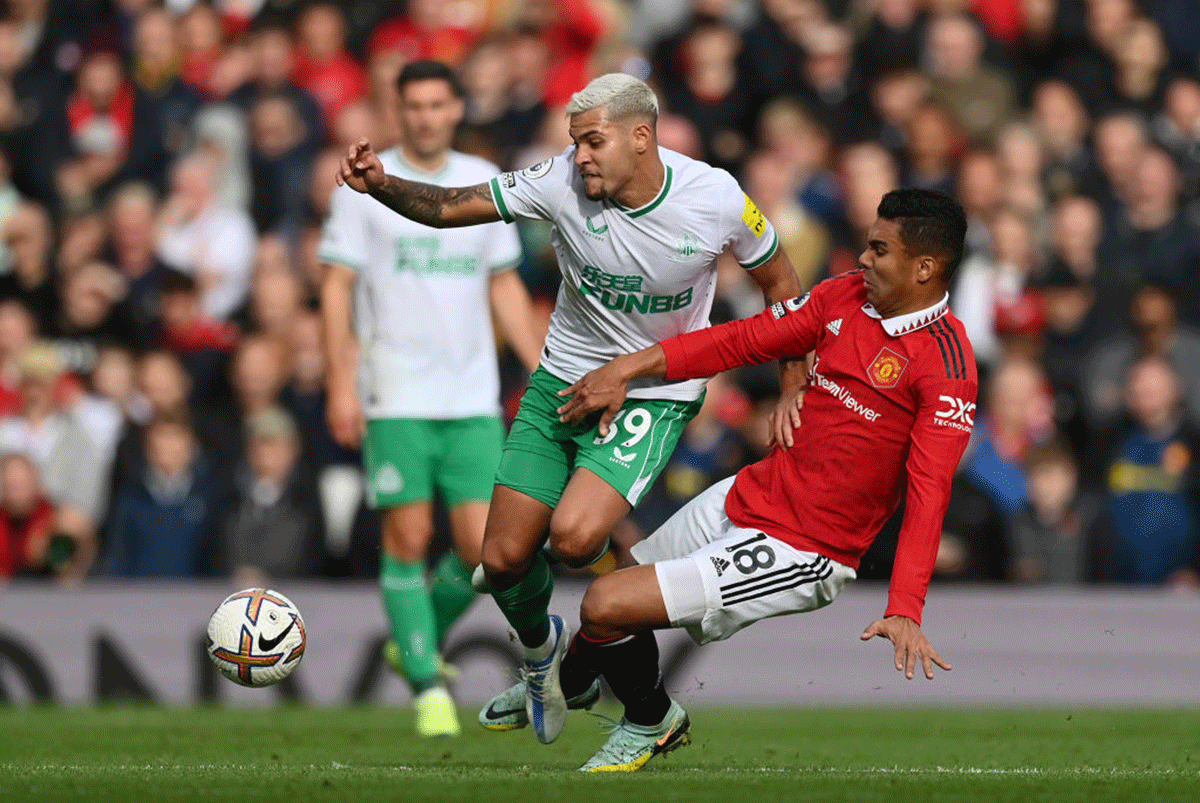 Newcastle United's Bruno Guimaraes is tackled by Manchester United's Casemiro