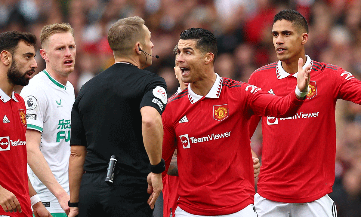 Manchester United's Cristiano Ronaldo argues with referee Craig Pawson before he is shown a yellow card during their match against Newcastle at Old Trafford