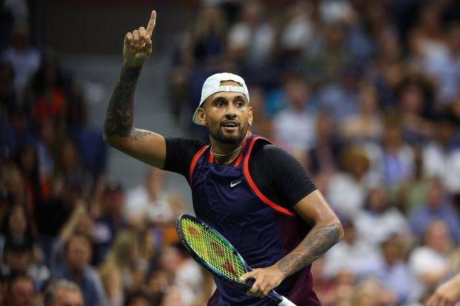 Nick Kyrgios celebrates after running around the net and hitting a ball that Daniil Medvedev had sent high in the air. That play cost him the point.