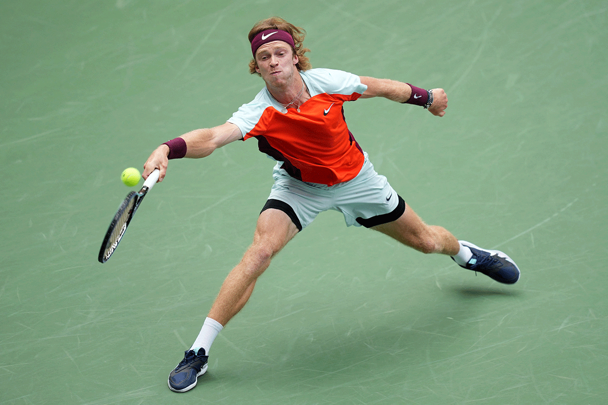 Andrey Rublev plays a return against Cameron Norrie