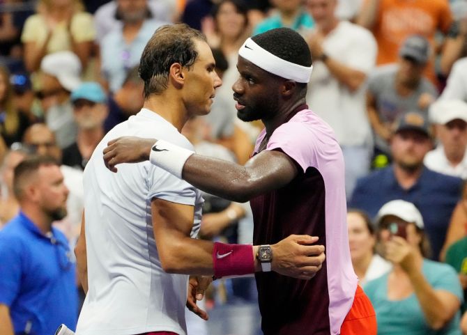 Rafael Nadal embraces Frances Tiafoe at the net after their match.
