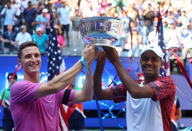 Joe Salisbury and Rajeev Ram of the United States celebrate with the trophy after defeating the Netherlands' Wesley Koolhof and Britain's Neal Skupski in the men's doubles final at the US Open on Friday.
