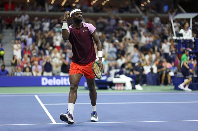 Frances Tiafoe celebrates winning the fourth set.