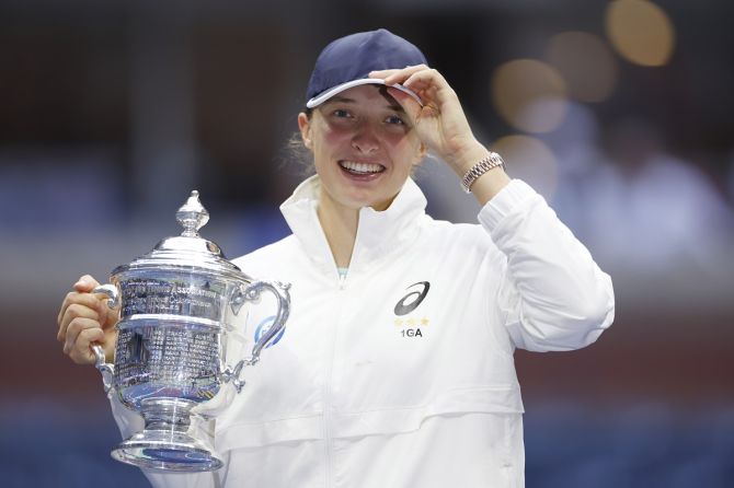 Poland's Iga Swiatek celebrates with the championship trophy after defeating Tunisia's Ons Jabeur in the US Open women’s singles final at USTA Billie Jean King National Tennis Center, New York City, on Saturday.