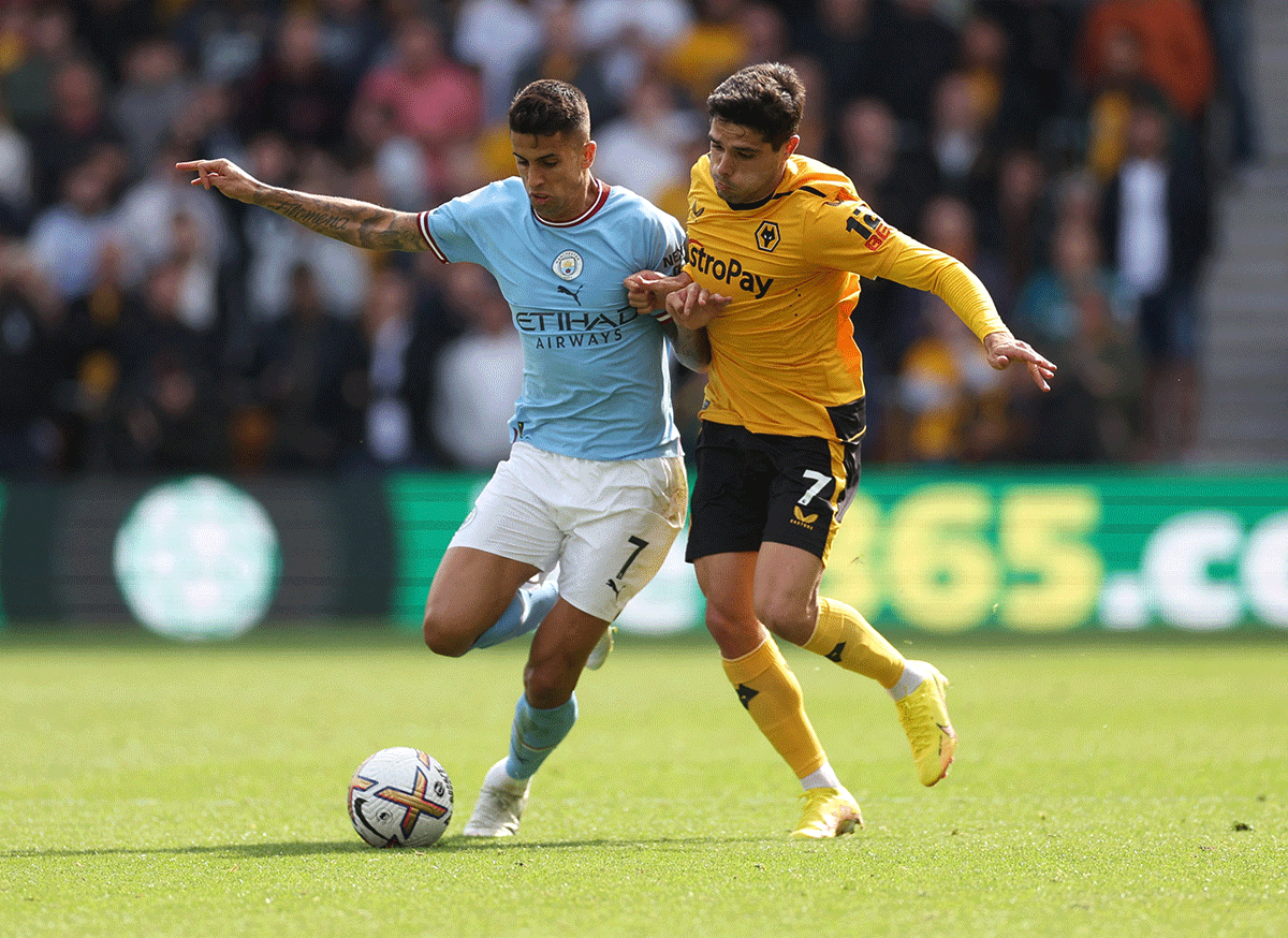Wolverhampton Wanderers' Pedro Neto and Manchester City's Joao Cancelo vie for possession 