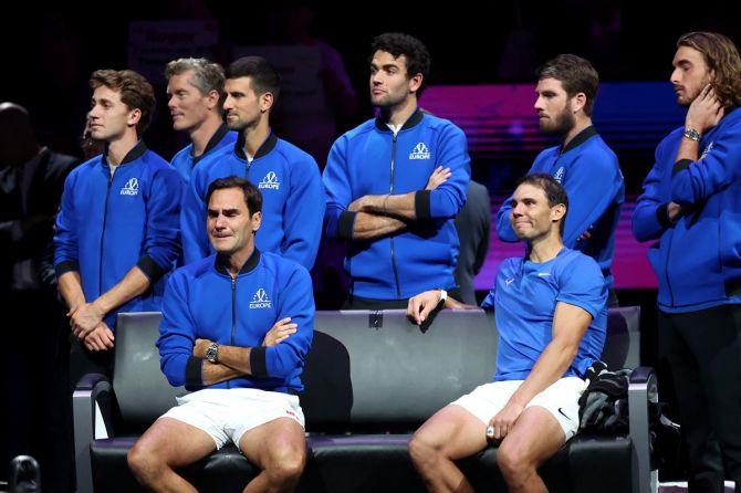 Members of Team Europe hold back tears as Roger Federer sits besides Rafael Nadal at the end of his last match.