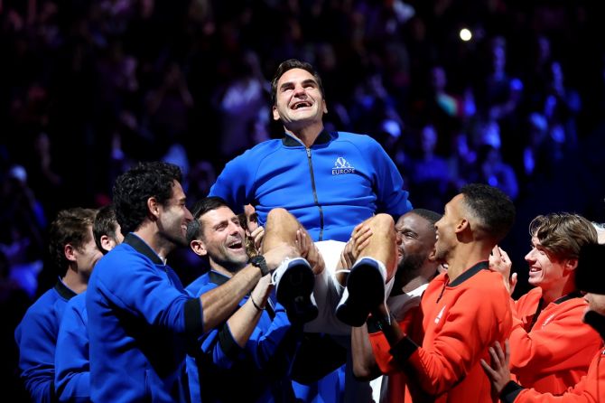 Team Europe and World members hoist Roger Federer at the end of his last match at the Laver Cup, at 02 Arena, London, on Friday night.