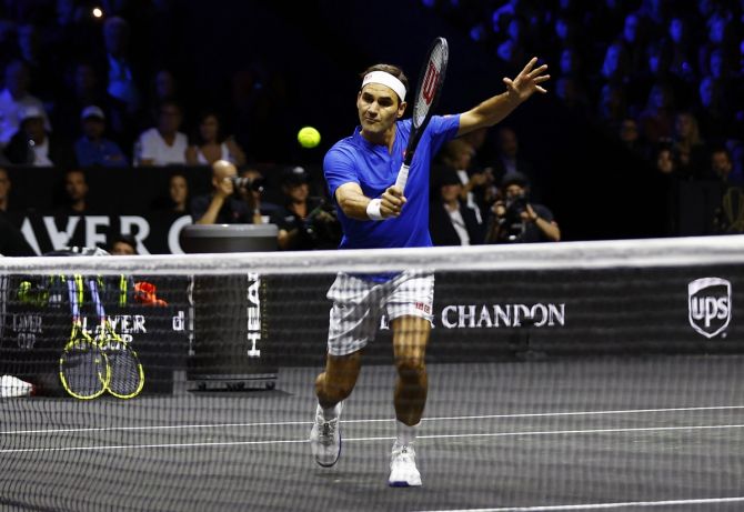 Team Europe's Roger Federer, who partnered Rafael Nadal, rushes to the net during the Laver Cup doubles match against Team World's Jack Sock and Frances Tiafoe.