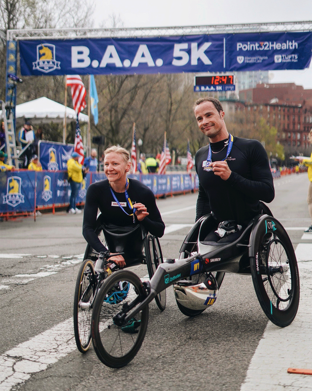 Swiss Olympic champion Marcel Hug and American Susannah Scaron smashed course records in the wheelchair division.