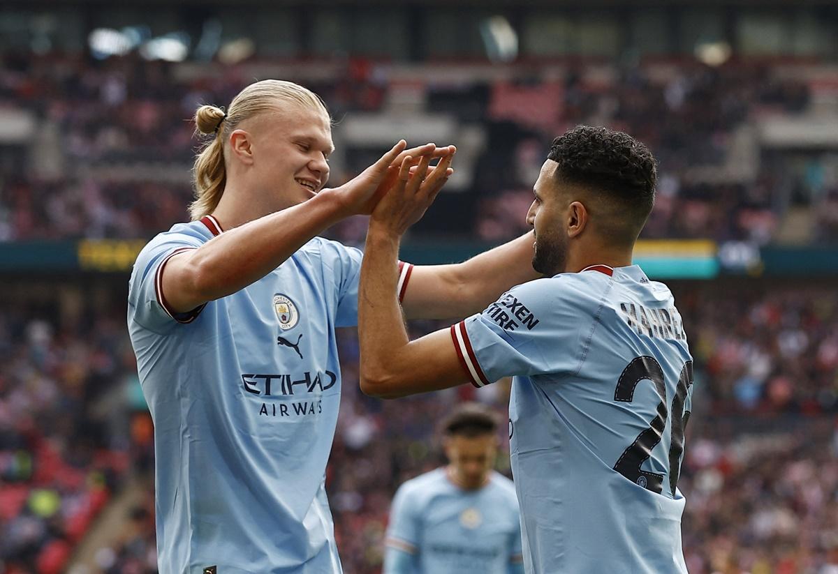 Riyad Mahrez celebrates scoring Manchester City's second goal with Erling Braut Haaland.